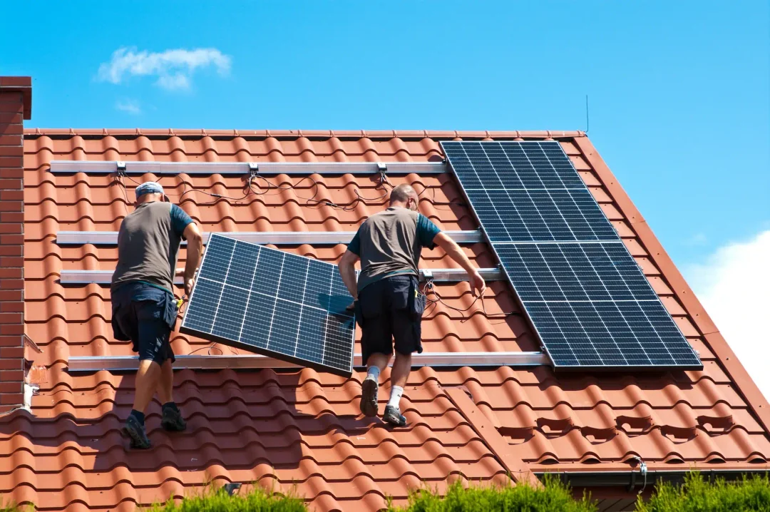 Two men working and providing a solar panel installation in a rooftop